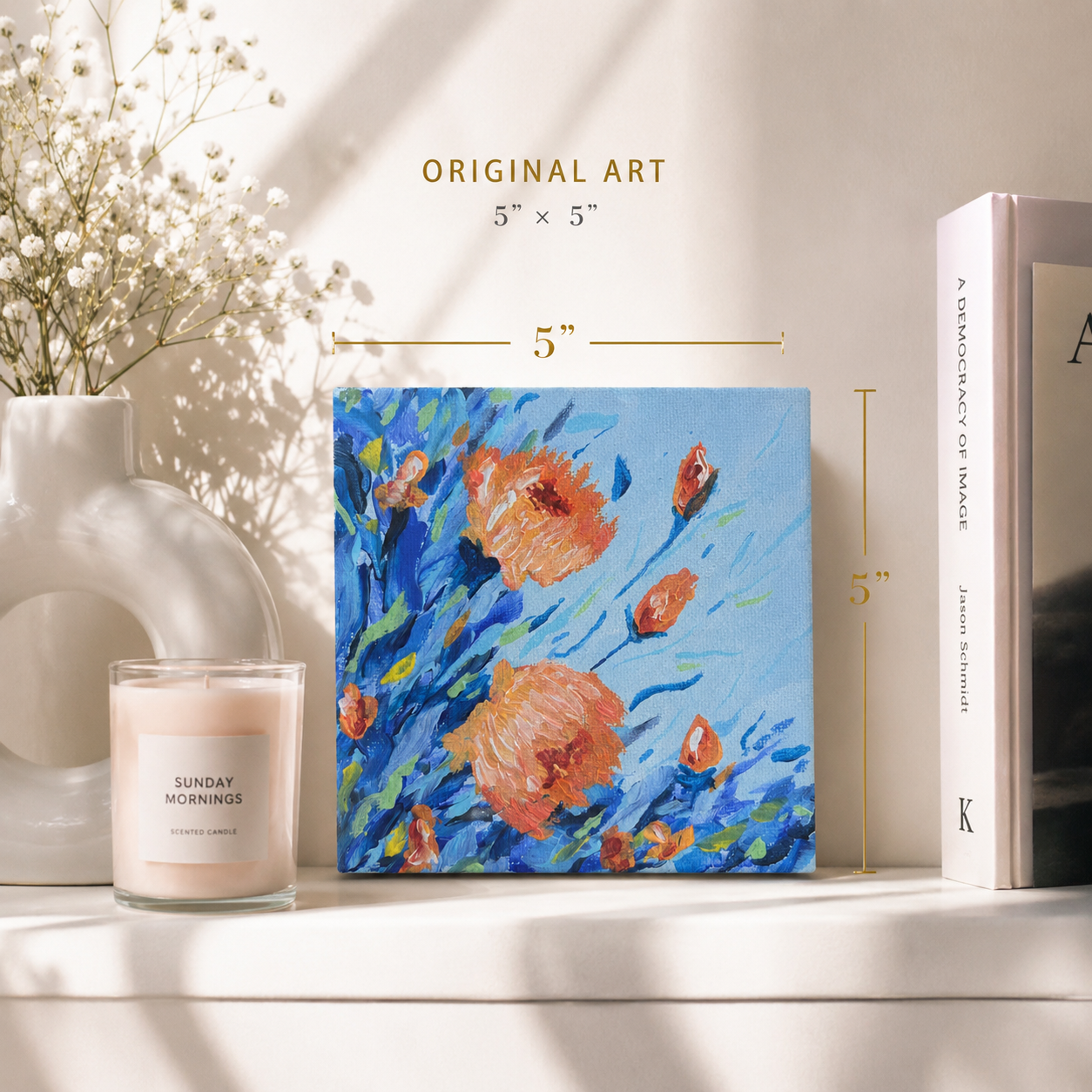 Floral notebook with a candle and book on a shelf

