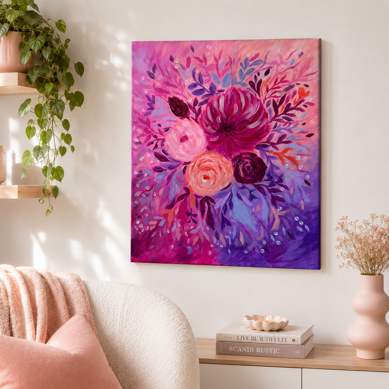 Colorful floral painting on a wall in a living room with a plant and books.