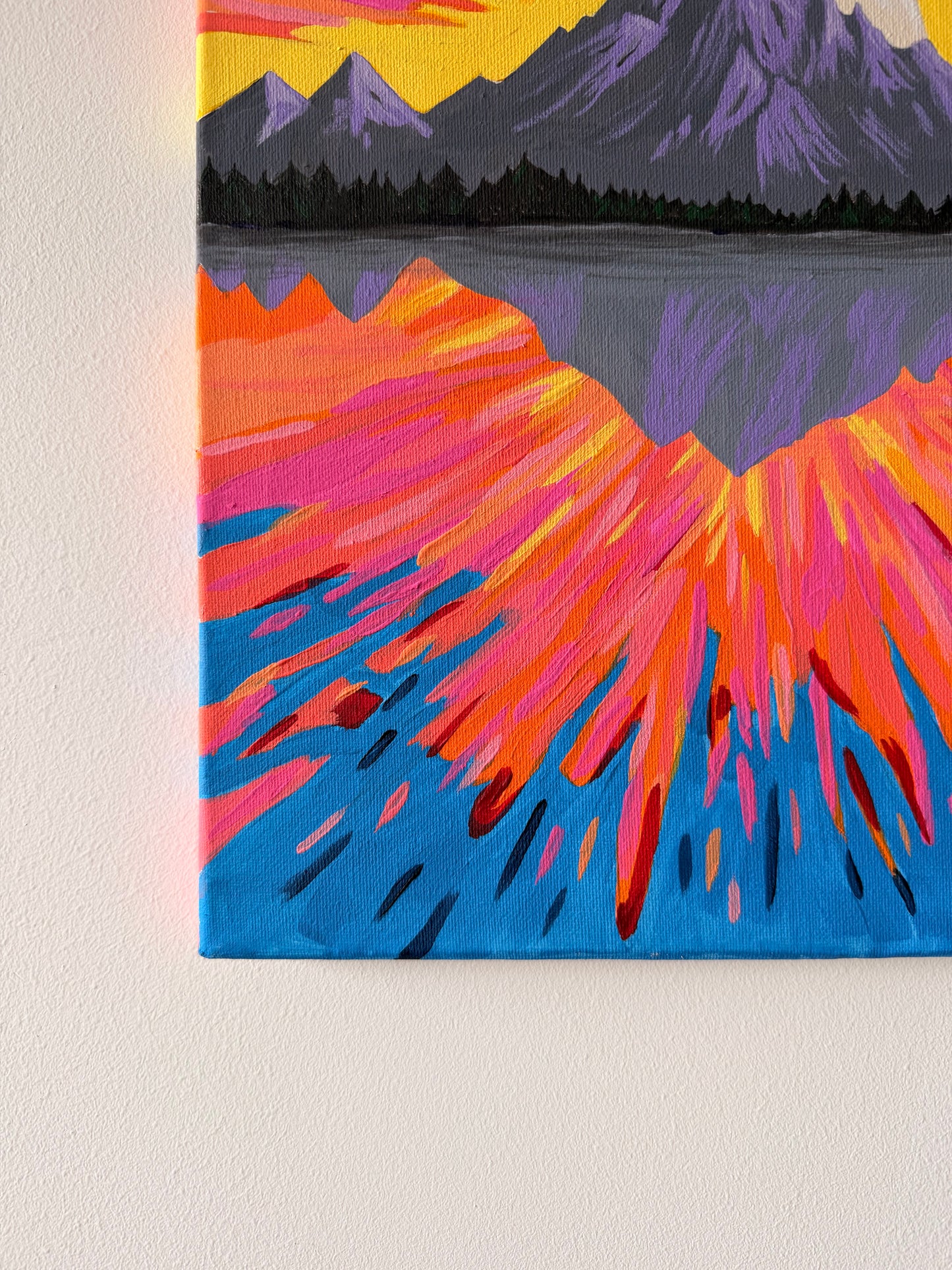 Canvas painting of a mountain landscape with vibrant colors on a plain background